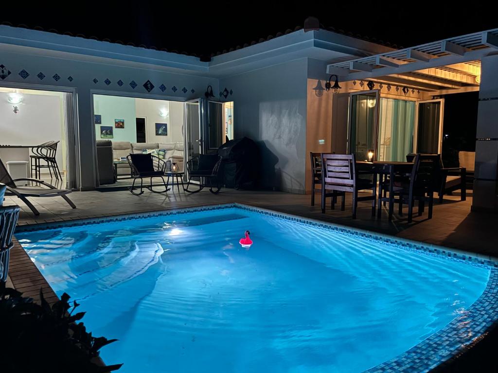 a swimming pool at night with a table and chairs at Beautiful Villa on the Sea in Lagun