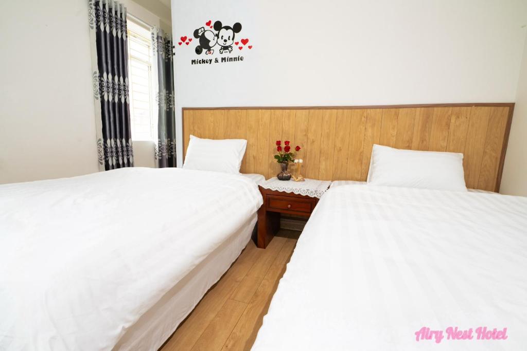 Postel nebo postele na pokoji v ubytování Airy Nest Hotel
