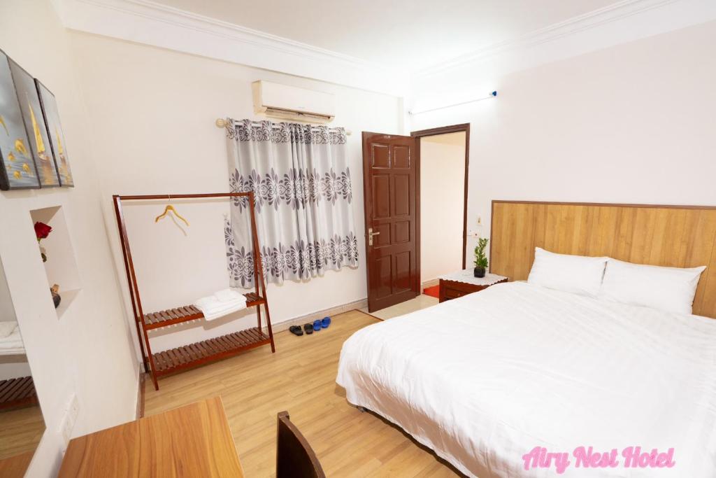 Postel nebo postele na pokoji v ubytování Airy Nest Hotel