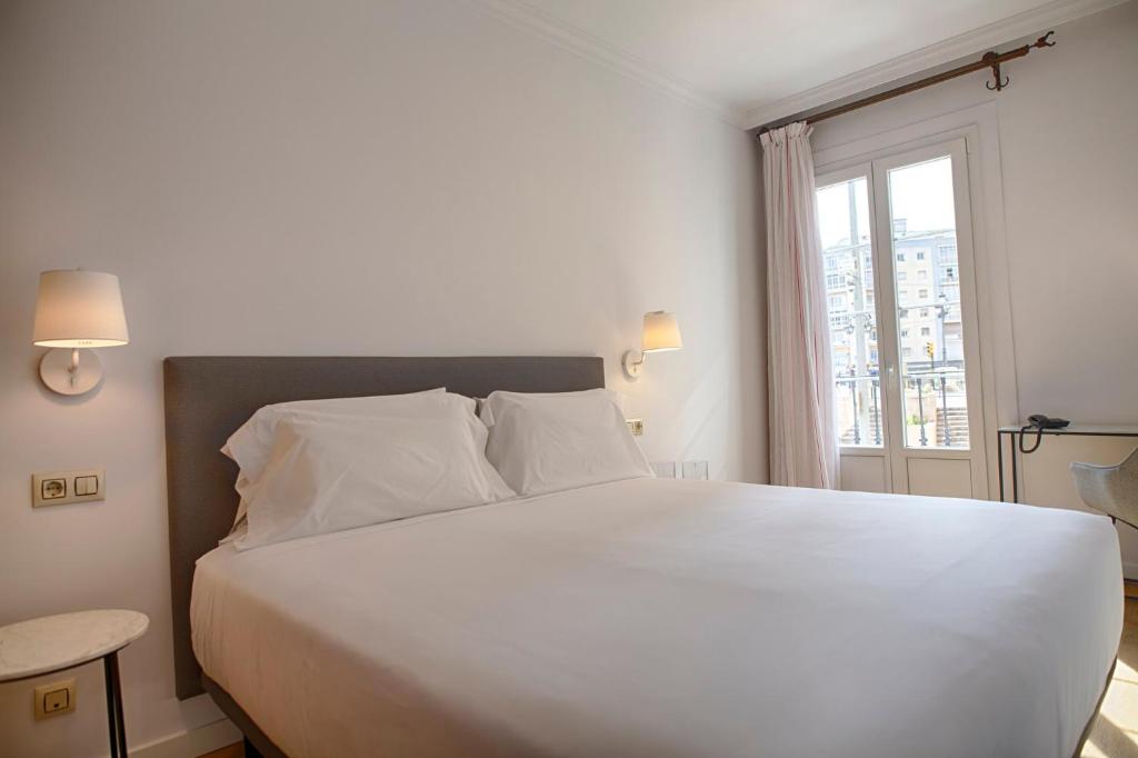 Cama o camas de una habitación en Sercotel Tribuna Málaga