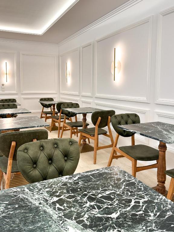a room with tables and chairs and a bunch of tables at Armata Boutique Hotel in Spetses