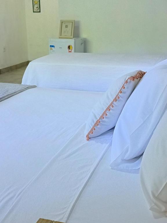 Postel nebo postele na pokoji v ubytování Timborana Suítes