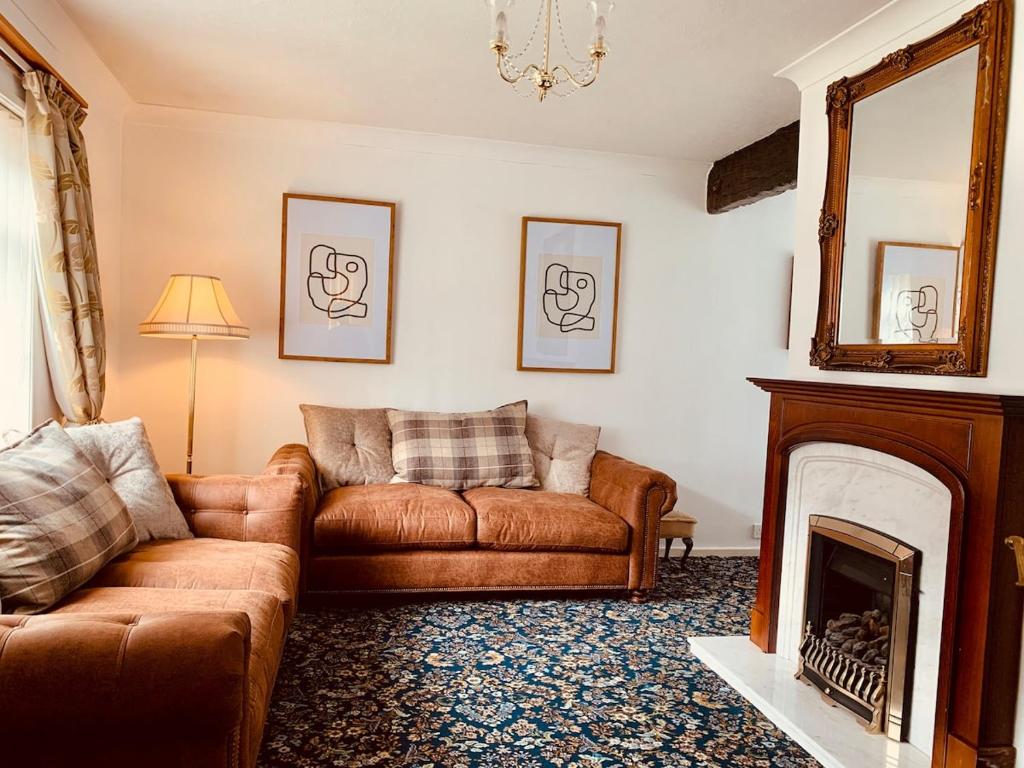 a living room with a couch and a fireplace at Home like 3 bed house Sheffield in Sheffield