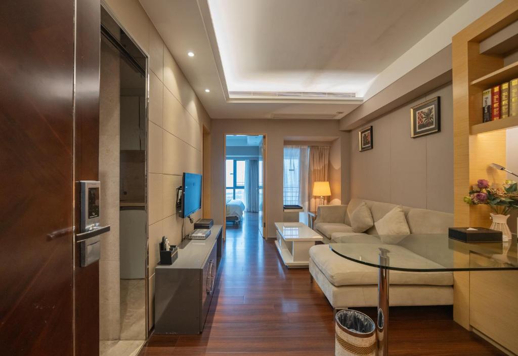 a living room with a couch and a table at Shenzhen Binhe Impression Hotel Apartments in Shenzhen