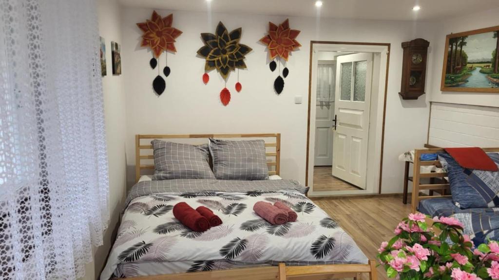 a bedroom with a bed with red pillows on it at Agroturystyka Przy Rajskim Sadzie in Nowy Berezów