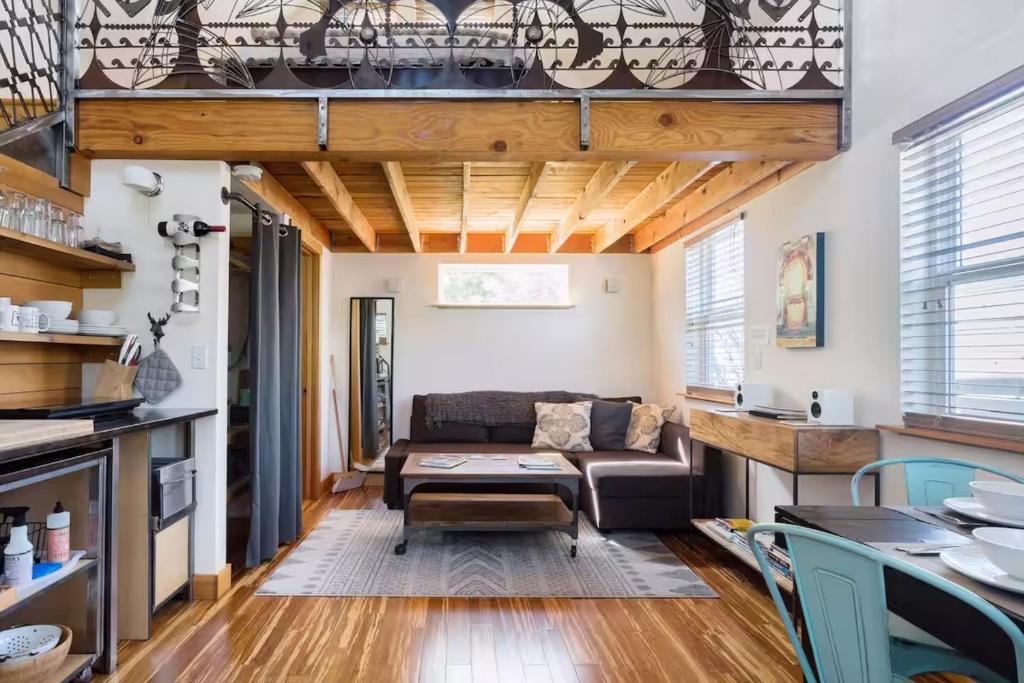 a living room with a couch and a table at Blue Door Micro-Loft in Portland