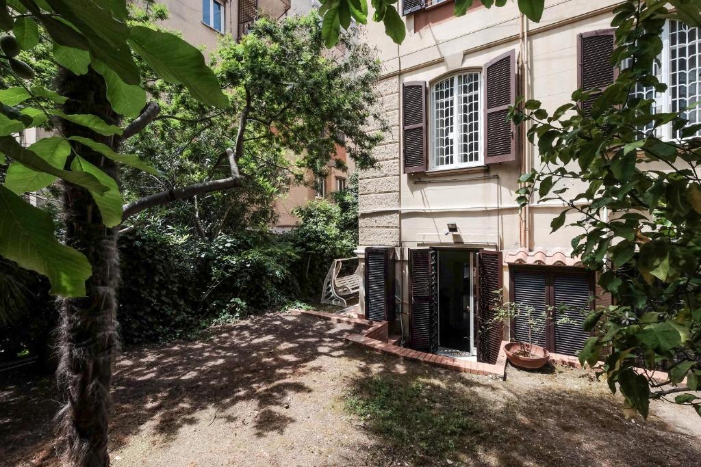 a house with a tree in front of a building at Villa Pamphili Classic Garden in Rome