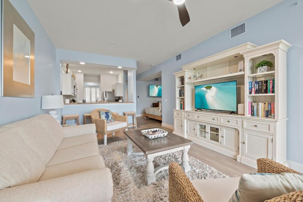 a living room with a couch and a tv at Golf Condo Views With Resort Pool and Amenities in Naples