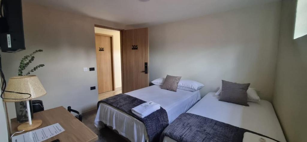 Postel nebo postele na pokoji v ubytování Hotel RUTA365