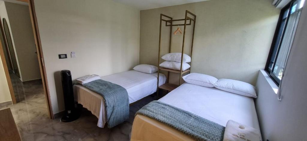 Postel nebo postele na pokoji v ubytování Hotel RUTA365