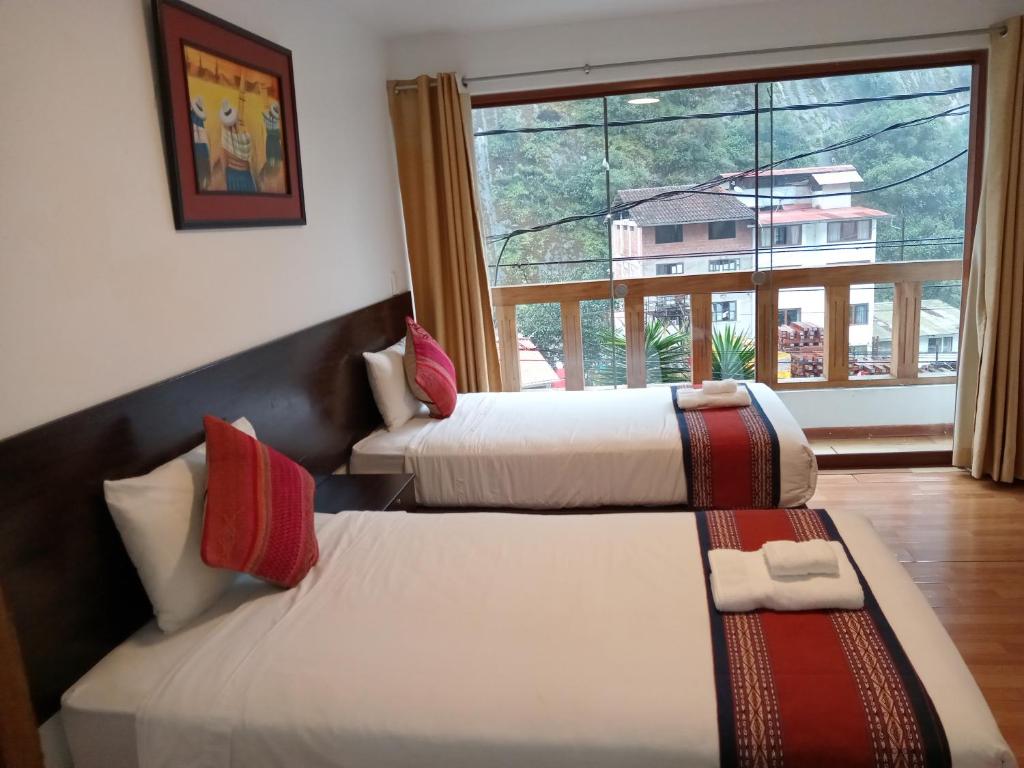 Postel nebo postele na pokoji v ubytování El Quetzal MachuPicchu