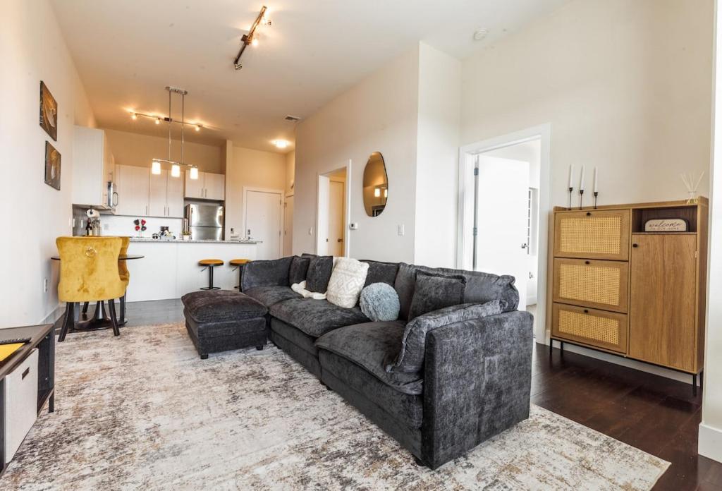 a living room with a couch and a kitchen at Prime Location min from Philly & Transit - in Norristown