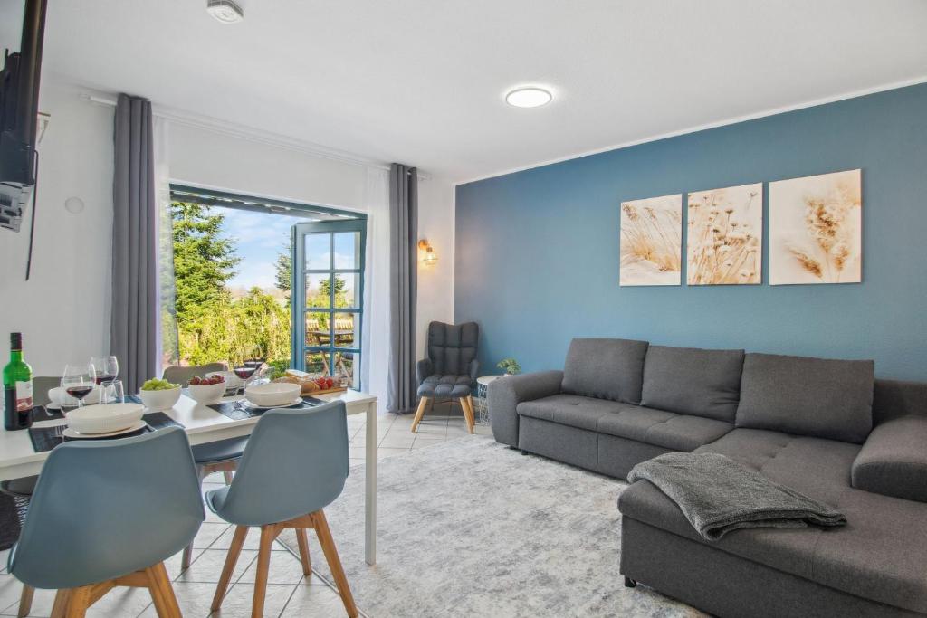 a living room with a couch and a table at Blue Pearl Dümmer-See Bungalow in Hüde