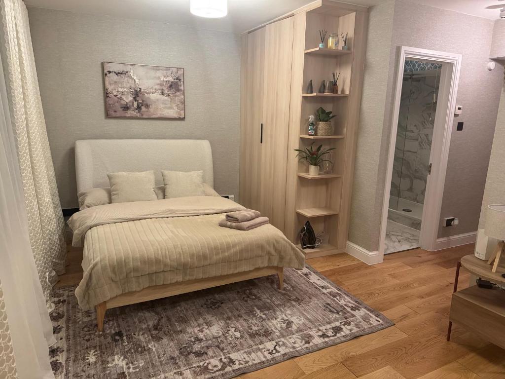 a small bedroom with a bed and a rug at Central London Studio Apartment in London