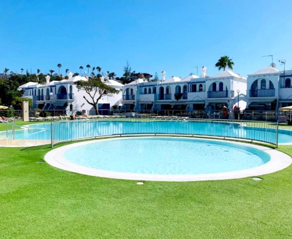 a large swimming pool in front of some houses at Maspalomas J&O in Maspalomas