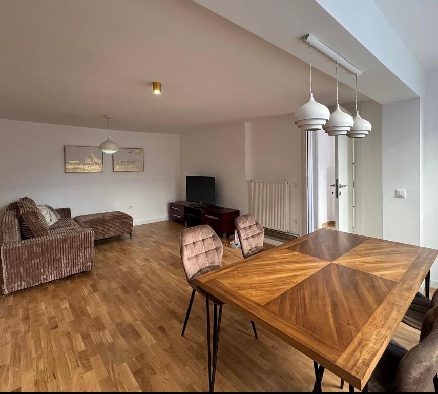 a living room with a wooden table and chairs at Moon night in Niš