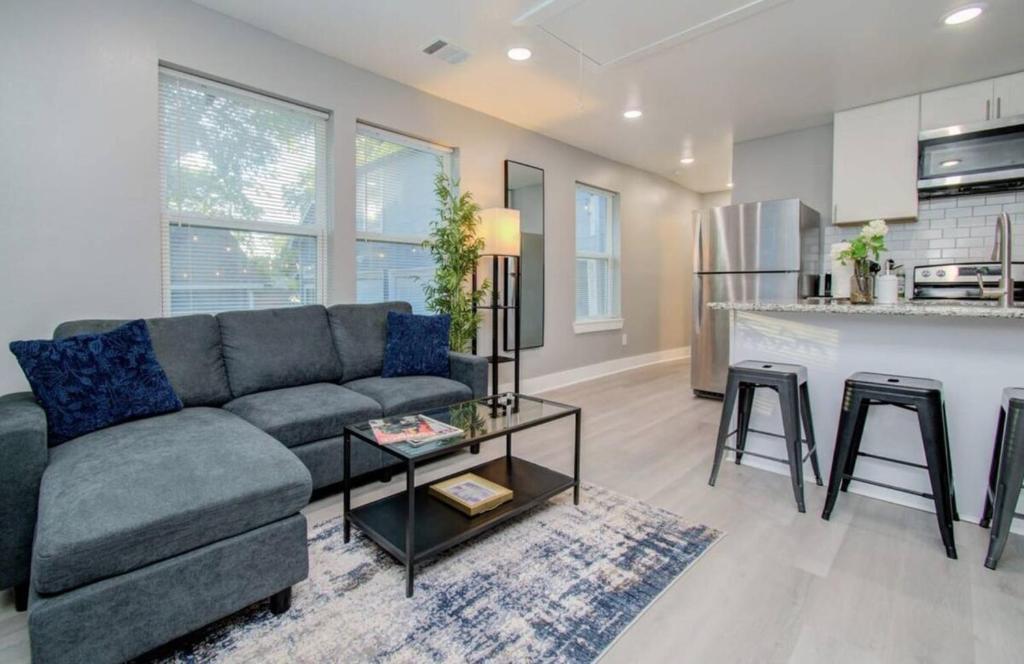 a living room with a couch and a kitchen at 2-Bedroom Townhouse in Houston in Houston