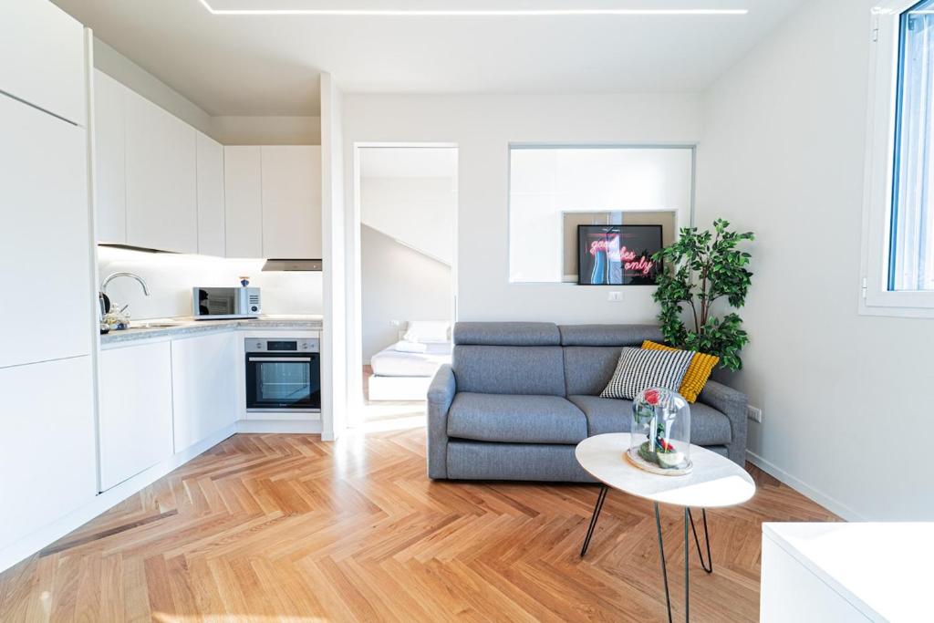 a living room with a couch and a table at BRERA LittleSuite DuomoView in Milan