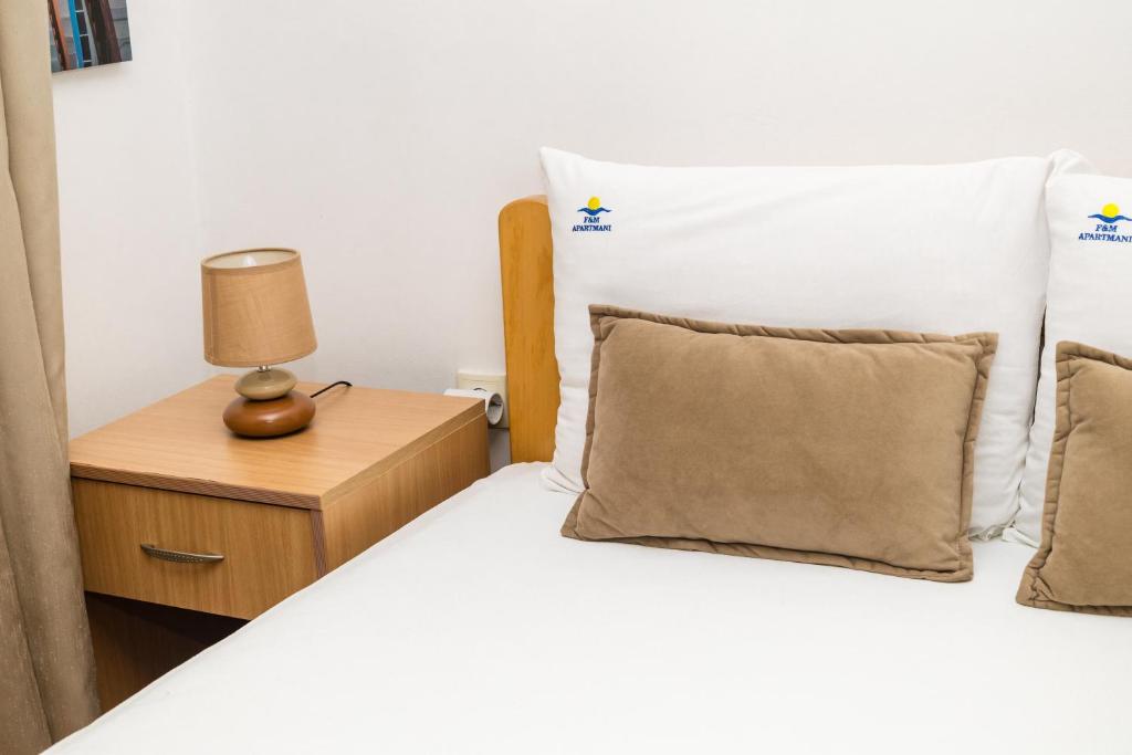 Posteľ alebo postele v izbe v ubytovaní Apartmani F&M