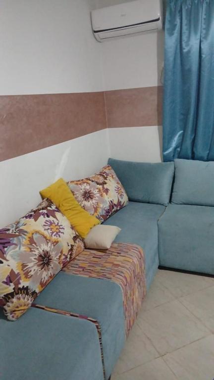 a blue couch with pillows on it in a room at Saidia palace in Saïdia