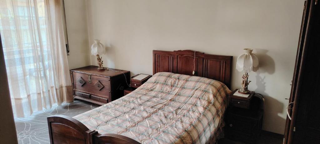 a bedroom with a bed and a dresser and a window at Room das Lindos in Mondim de Basto