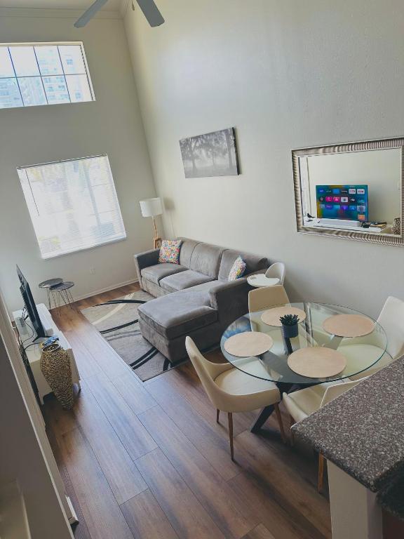 a living room with a couch and a table and chairs at Loft Style,2 Beds ,Flexible self check in,Pool in Marina del Rey