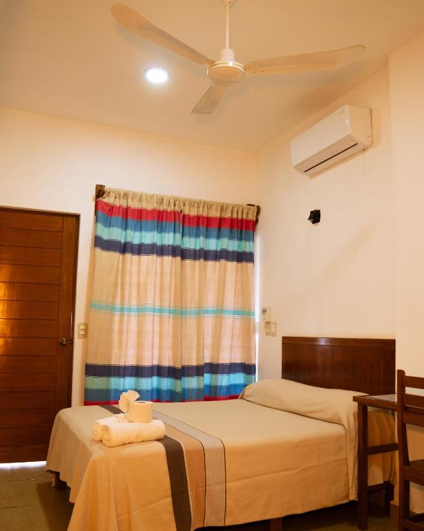a bedroom with two beds and a window at Hotel VidaMar in Puerto Escondido