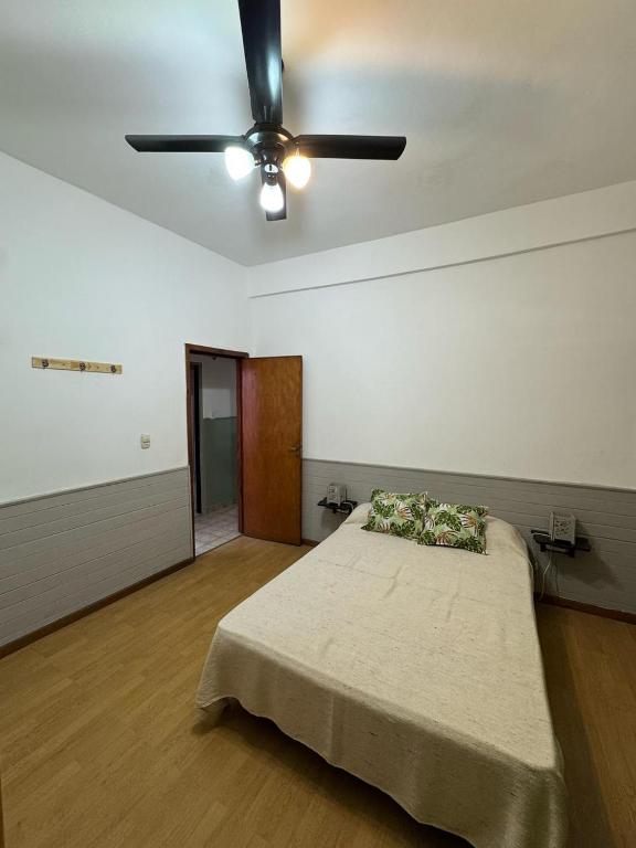 a bedroom with a bed and a ceiling fan at CasaSansaba in Gerli