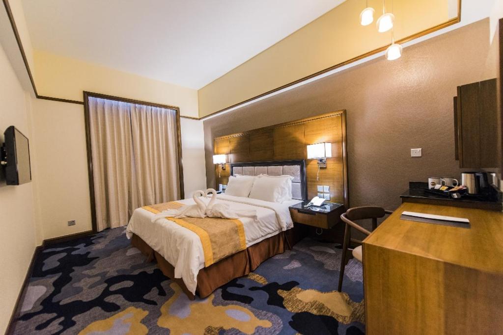 Postel nebo postele na pokoji v ubytování NU Hotel