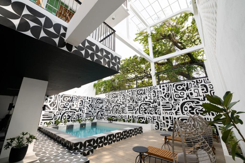 a pool in a building with a patterned wall at Kadangyan by 3BU Hostel in San Fernando