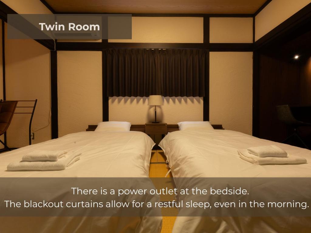 Postel nebo postele na pokoji v ubytování BUNA KUSATSU Onsen Inn