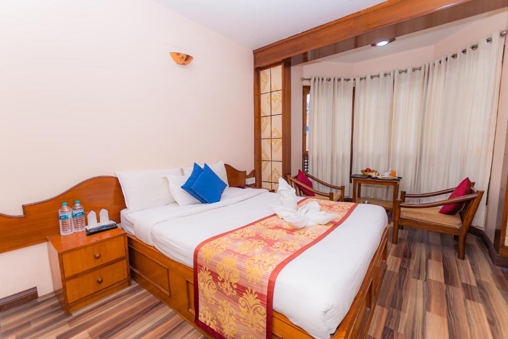 Postel nebo postele na pokoji v ubytování Amber Royel Hotel