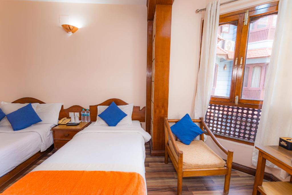 Postel nebo postele na pokoji v ubytování Amber Royel Hotel