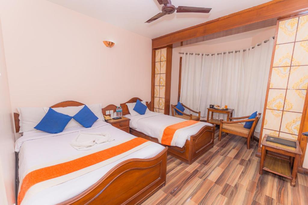 Postel nebo postele na pokoji v ubytování Amber Royel Hotel
