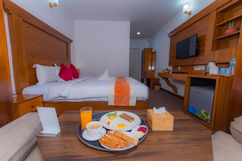 Postel nebo postele na pokoji v ubytování Amber Royel Hotel