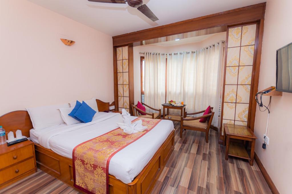 Postel nebo postele na pokoji v ubytování Amber Royel Hotel