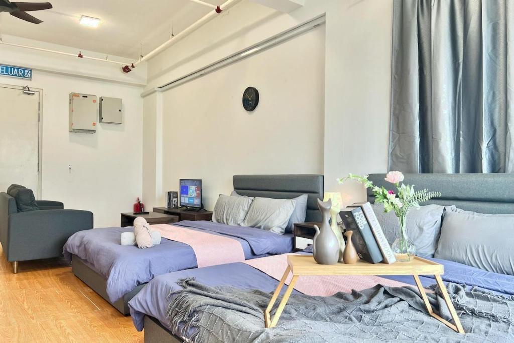 a room with two beds and a couch at G10 6Pax Sunway Medical Center Geo Avenue WiFi TV in Subang Jaya