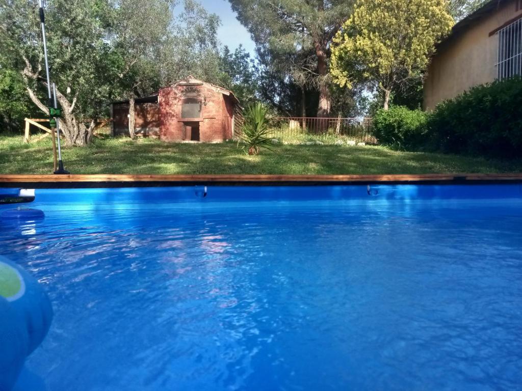 a swimming pool in front of a house at La Casa del Grillo in Viterbo