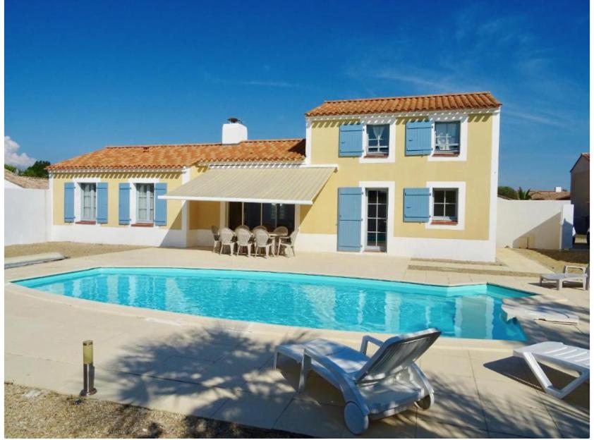 a house with a swimming pool in front of a house at Sunset in Saint-Jean-de-Monts