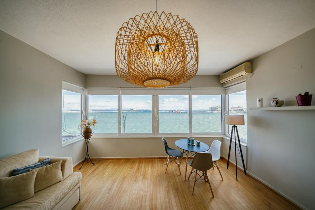 a living room with a table and a chandelier at Faros in Chios
