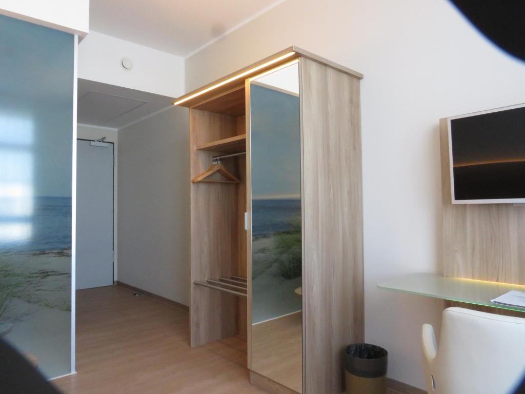 TV a/nebo společenská místnost v ubytování DLRG Tagungszentrum Hotel Delphin