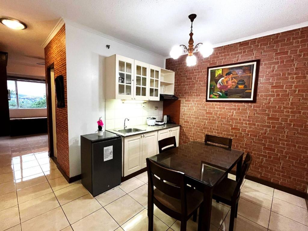 a kitchen and dining room with a table and a counter at Room in Albegro Baguio Burnham Wifi Parking in Baguio