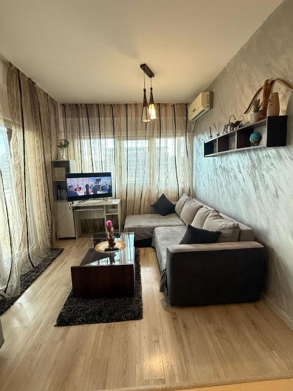 a living room with a couch and a table at Apartament Karina in Dudu