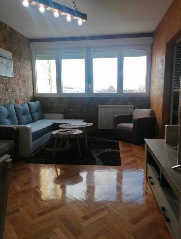 a living room with a couch and a table at TINAa in Kragujevac