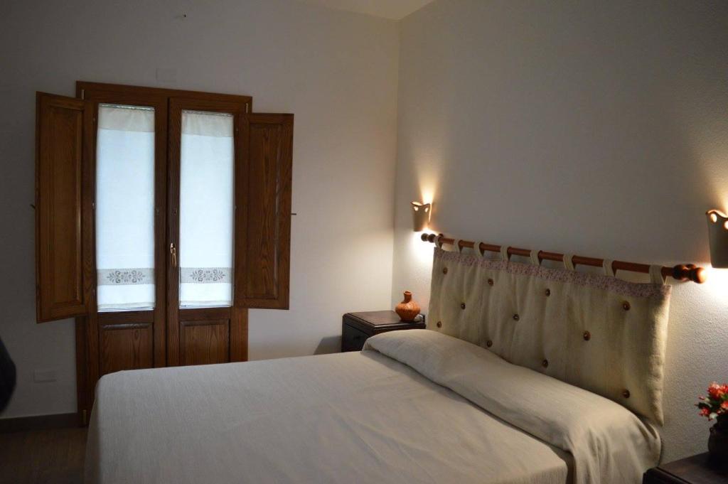 Postel nebo postele na pokoji v ubytování Agriturismo S'Orgiola