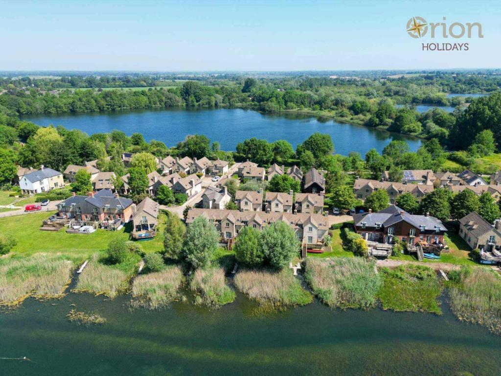 an aerial view of a large house with a lake at Mill Village 75, Tide Cottage - P in Somerford Keynes