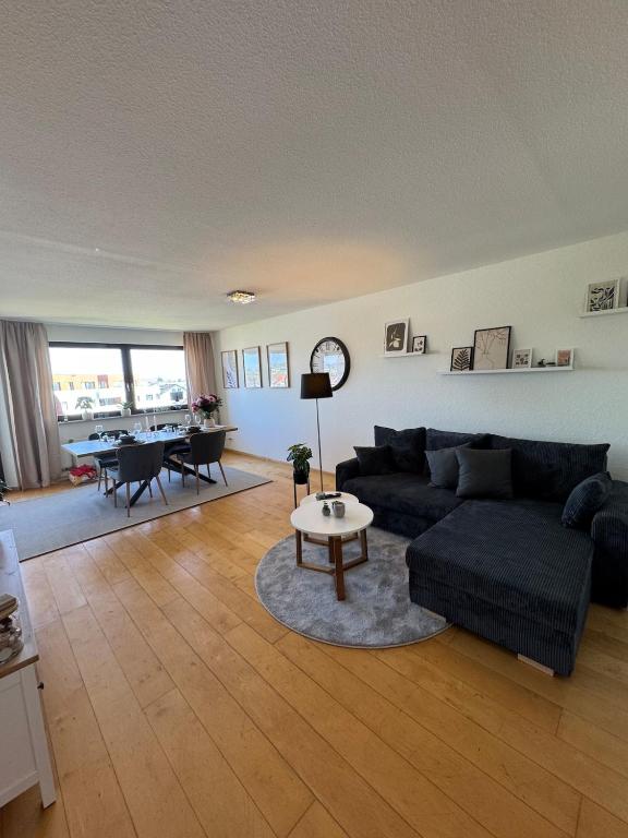 a living room with a couch and a table at Emelies Sonnenwohnung mit Balkon in Efringen-Kirchen