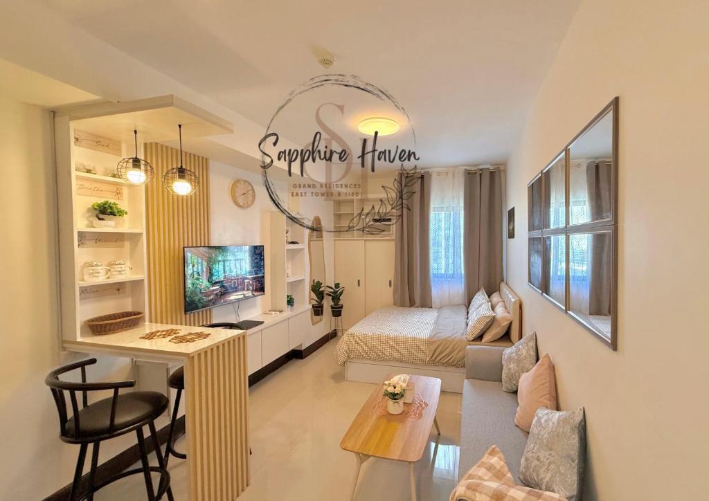 a small living room with a bed and a table at Sapphire Haven at Grand Residences Cebu East Tower B in Cebu City