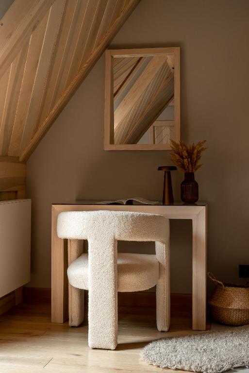 a white table with a chair and a mirror at Villa Las Apartamenty in Zakopane