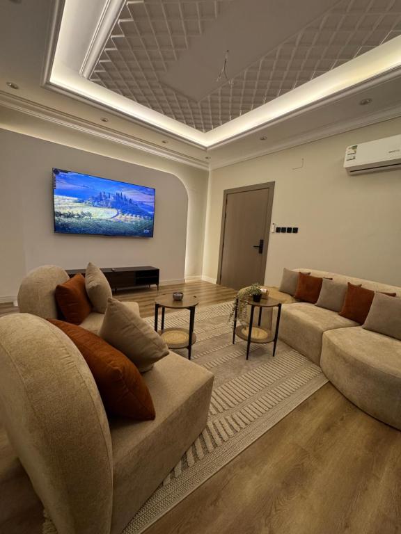 a living room with a couch and a table at Suits apartment in AlUla